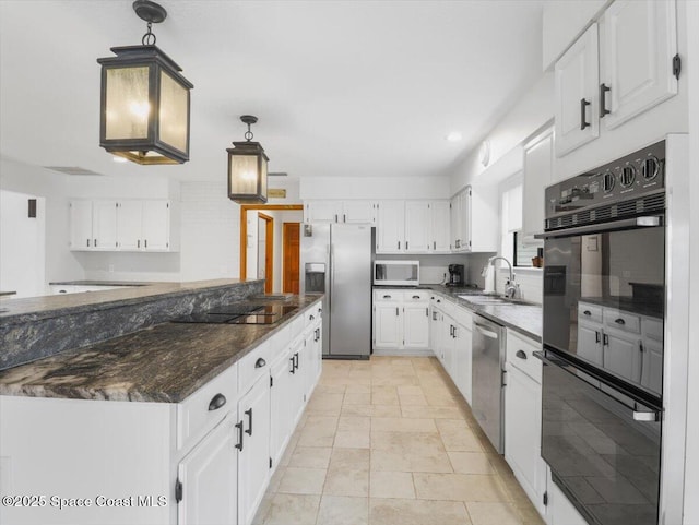 kitchen with decorative light fixtures, white cabinetry, sink, and black appliances