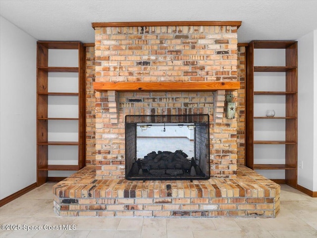 details with a brick fireplace and a textured ceiling