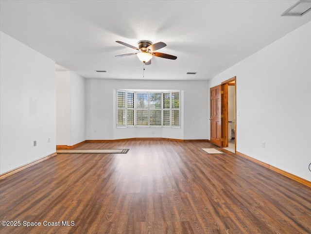 spare room featuring ceiling fan and dark hardwood / wood-style floors