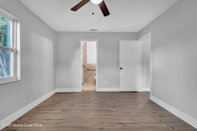 empty room with light hardwood / wood-style flooring and ceiling fan