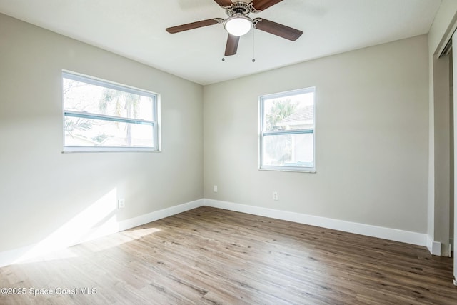 unfurnished room featuring ceiling fan, plenty of natural light, and light wood-type flooring