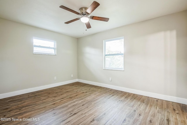 unfurnished room featuring ceiling fan, a healthy amount of sunlight, and wood-type flooring