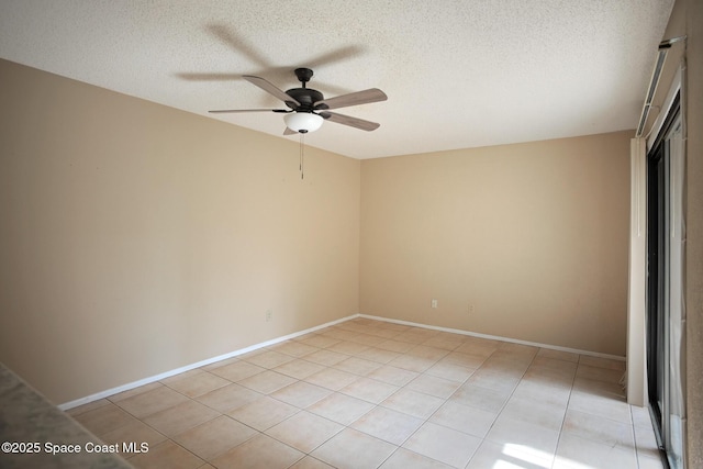 empty room with ceiling fan, a textured ceiling, and light tile patterned flooring