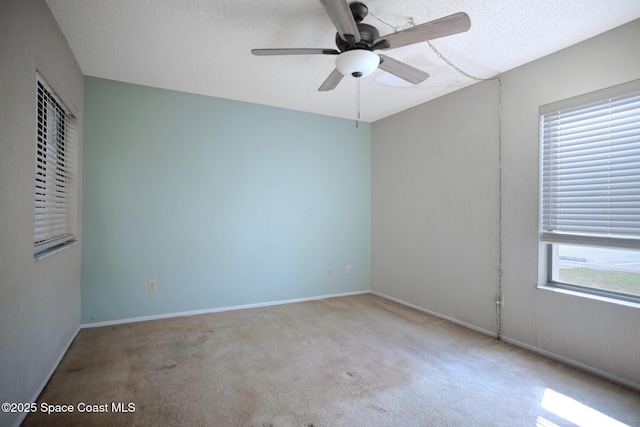 spare room with light carpet, a textured ceiling, and ceiling fan