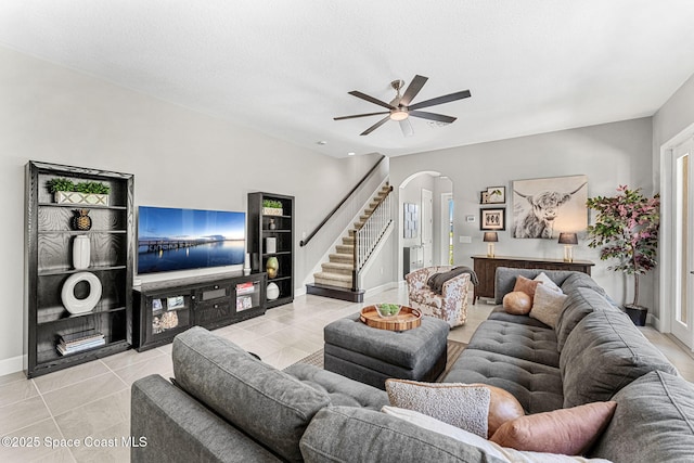 tiled living room featuring a textured ceiling and ceiling fan