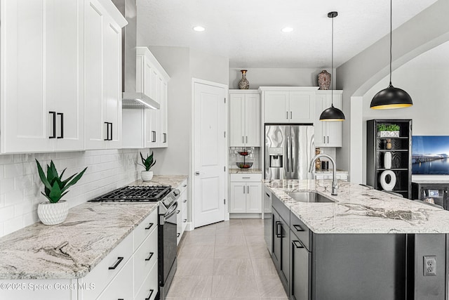 kitchen featuring sink, stainless steel appliances, hanging light fixtures, and white cabinets