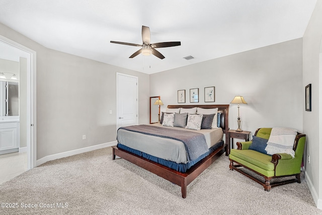 carpeted bedroom featuring ceiling fan and ensuite bath