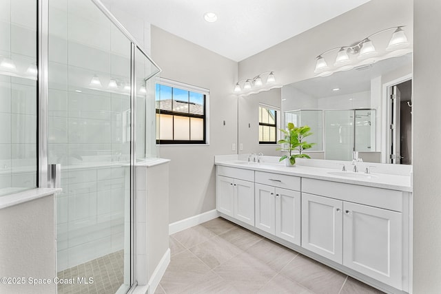 bathroom featuring tile patterned flooring, vanity, and a shower with shower door