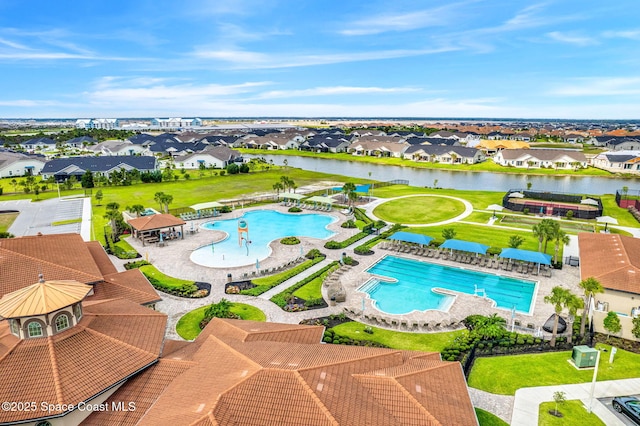 view of pool featuring a patio and a water view