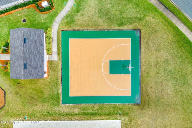 view of basketball court with a yard