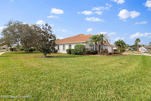 view of front of house featuring a garage and a front yard