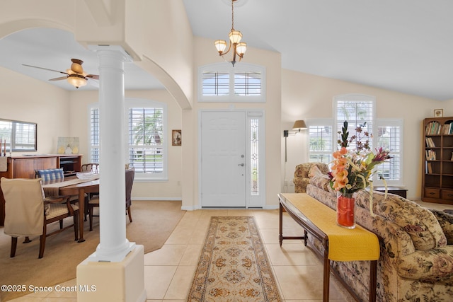 foyer featuring a wealth of natural light, light tile patterned floors, and ornate columns