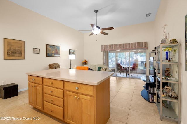 kitchen with a center island, light tile patterned floors, and ceiling fan