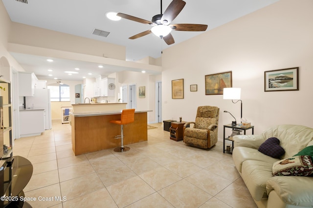 tiled living room featuring ceiling fan