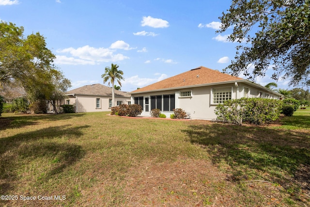 rear view of house with a yard