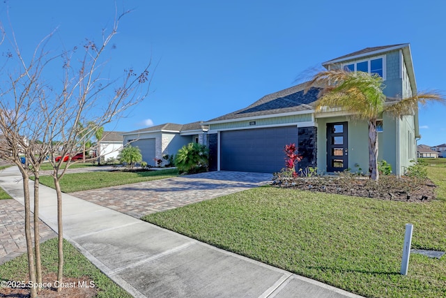 view of front of home with a garage and a front yard