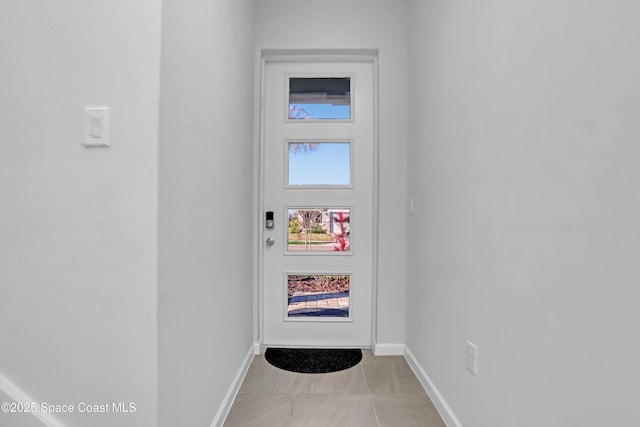 doorway featuring light tile patterned flooring