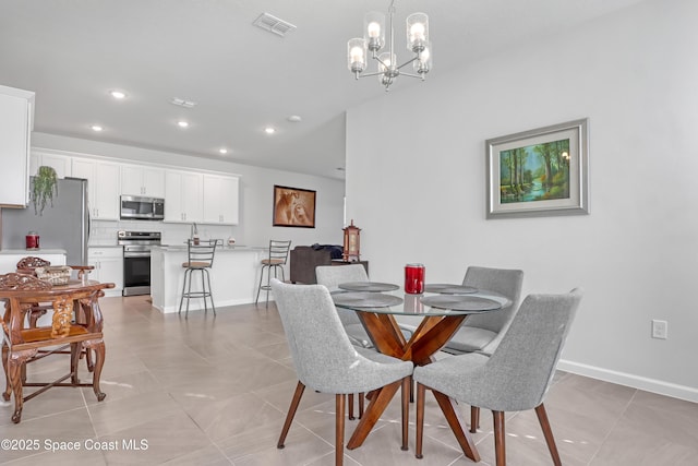 tiled dining room featuring a chandelier