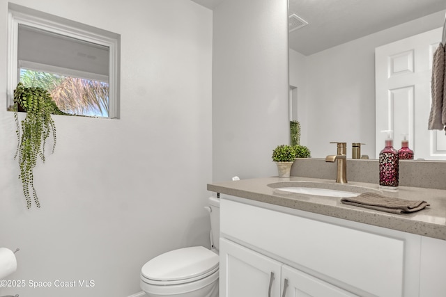 bathroom featuring vanity and toilet