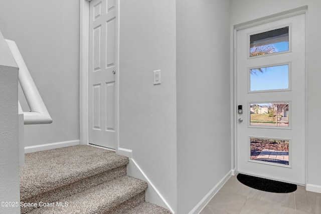 entrance foyer featuring light colored carpet