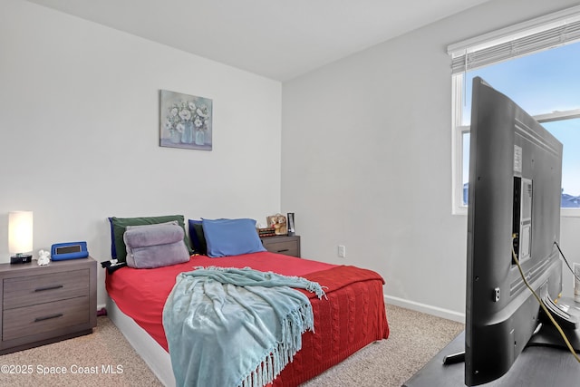 bedroom featuring light colored carpet