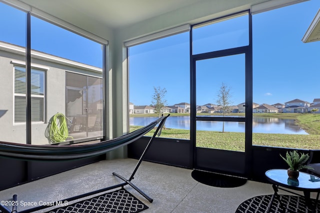 sunroom / solarium with a wealth of natural light and a water view