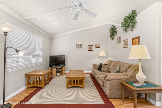 living room featuring ornamental molding, vaulted ceiling, baseboards, and wood finished floors