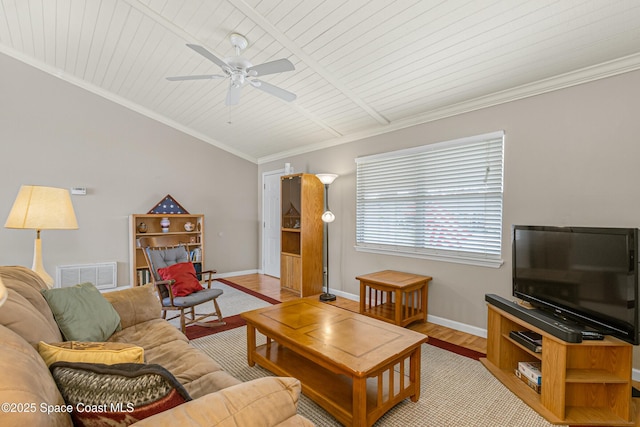 living room featuring lofted ceiling, visible vents, baseboards, light wood finished floors, and crown molding