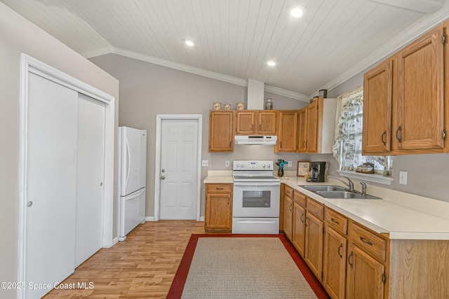 kitchen with white appliances, lofted ceiling, light countertops, under cabinet range hood, and a sink