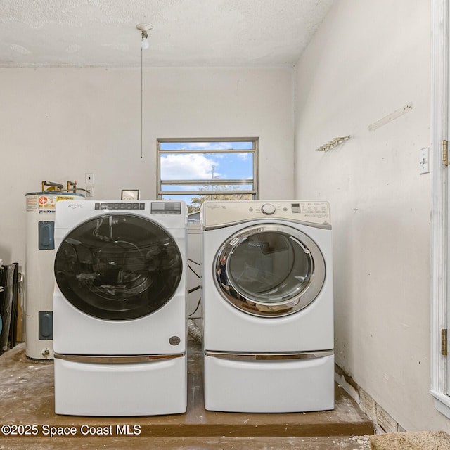 laundry area featuring laundry area, independent washer and dryer, a textured ceiling, and electric water heater