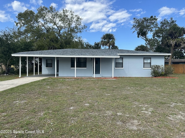 ranch-style home featuring a carport, covered porch, and a front lawn