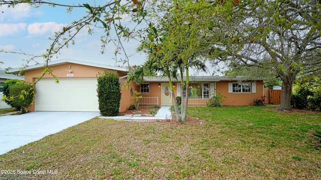 ranch-style house with stucco siding, an attached garage, concrete driveway, and a front lawn