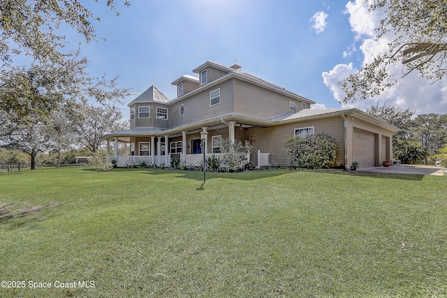 view of front of home featuring cooling unit, a garage, a front yard, and a porch