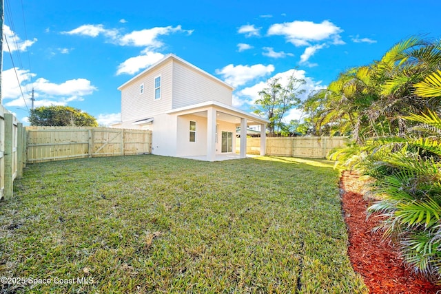 rear view of house featuring a patio and a lawn