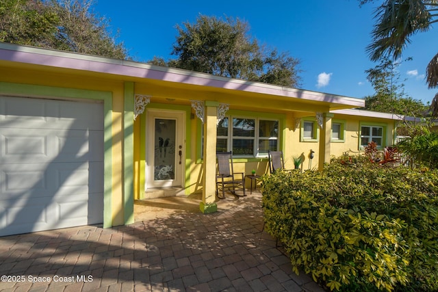 view of front of property featuring a garage and a porch