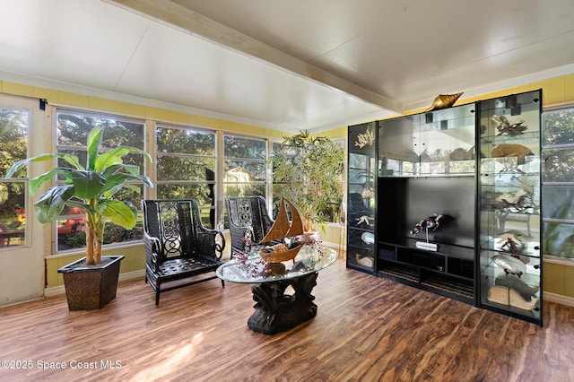 living room featuring wood-type flooring and beamed ceiling