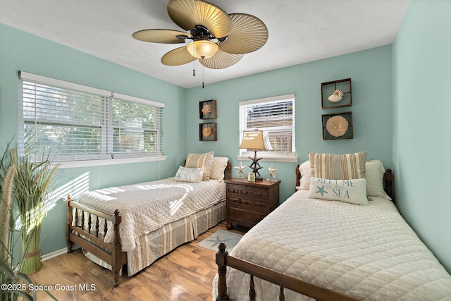 bedroom with ceiling fan and light hardwood / wood-style floors