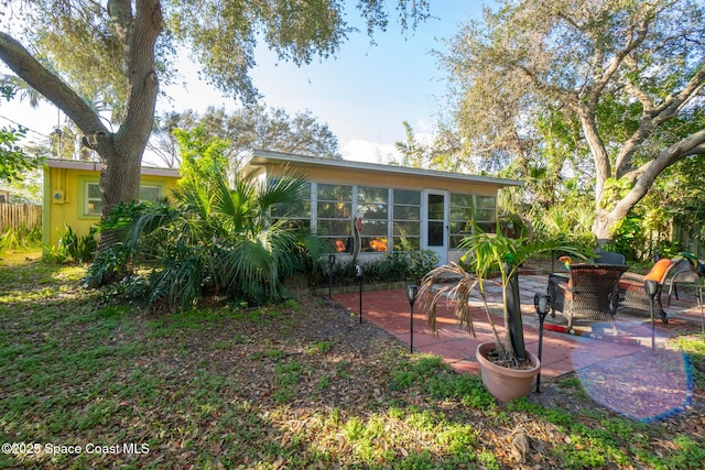 back of property featuring a patio and a sunroom