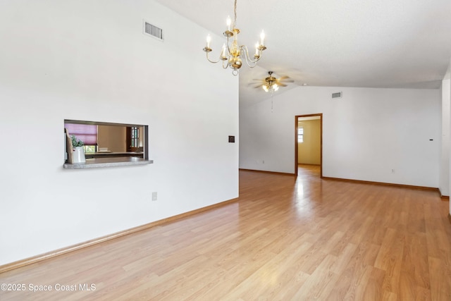 unfurnished room with ceiling fan with notable chandelier, lofted ceiling, and light hardwood / wood-style floors