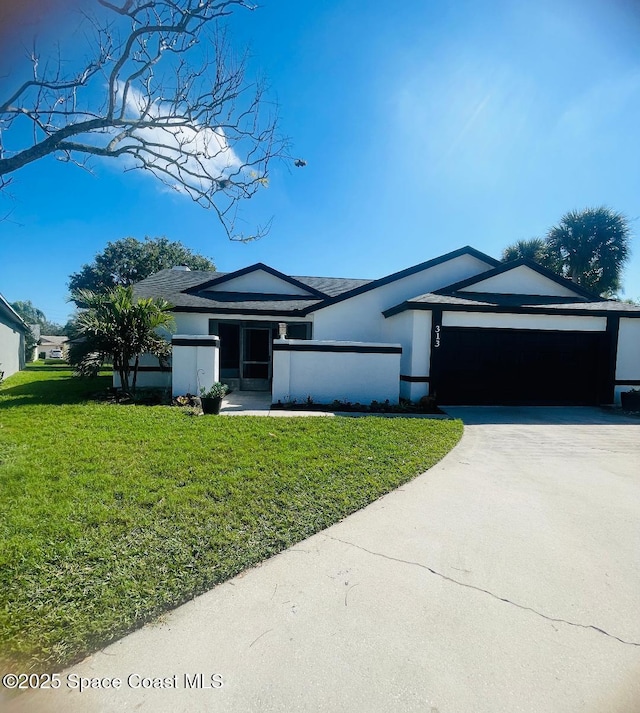 view of front of home with a garage and a front yard