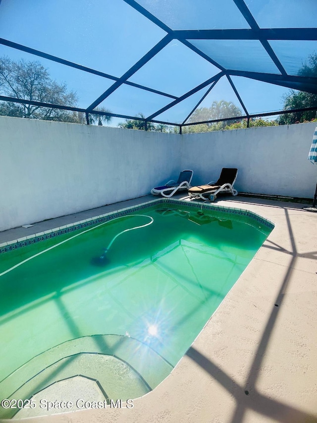 view of pool featuring a lanai