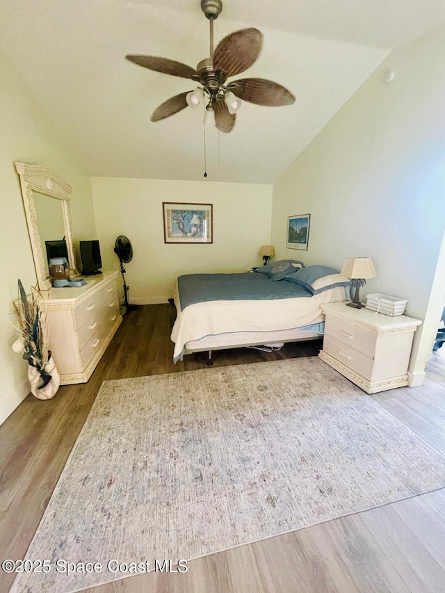 bedroom featuring wood-type flooring, lofted ceiling, and ceiling fan