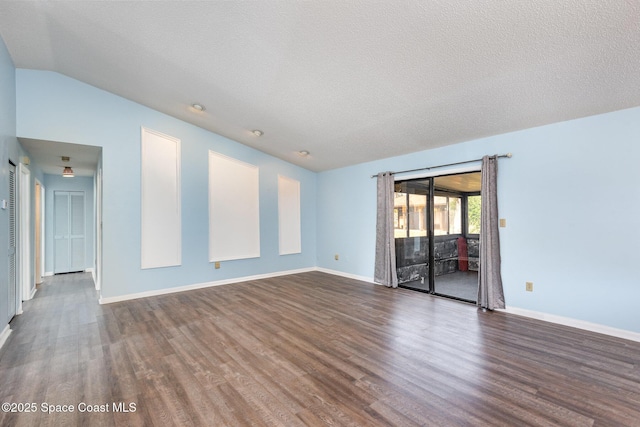 spare room with a textured ceiling, baseboards, and dark wood-style flooring