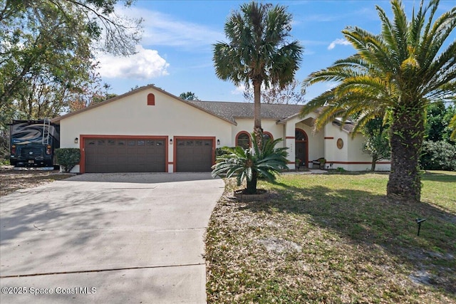 view of front of home with a garage and a front yard