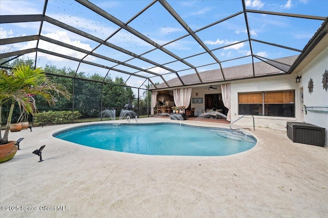 view of swimming pool with pool water feature, ceiling fan, a lanai, and a patio area