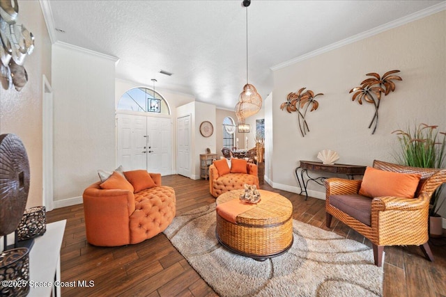 living room featuring dark hardwood / wood-style flooring, crown molding, and a textured ceiling