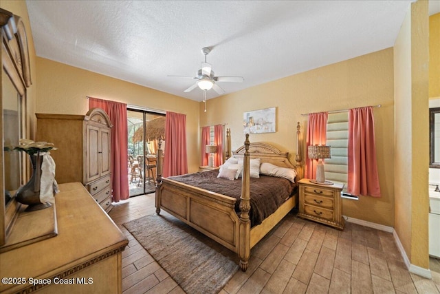 bedroom featuring ceiling fan, hardwood / wood-style flooring, access to outside, and a textured ceiling