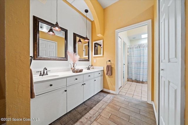 bathroom with hardwood / wood-style flooring and vanity