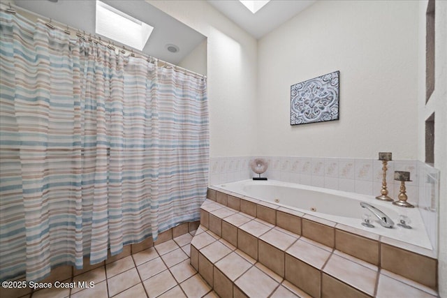 bathroom featuring tiled tub, tile patterned floors, and a skylight