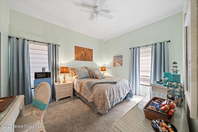 bedroom featuring light carpet and ceiling fan